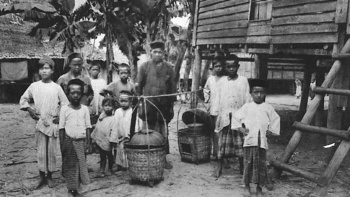 Black and white photo of early Malay settlers in Singapore kampong 