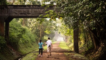 Two people walking along the Rail Corridor