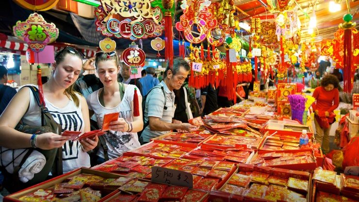 Hình chụp góc rộng du khách mua những bao lì xì đỏ ở Chinatown