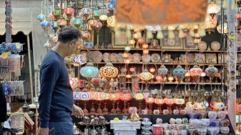 Một người khách qua đường đang ngắm những chiếc đèn lồng treo ở chợ Geylang Serai